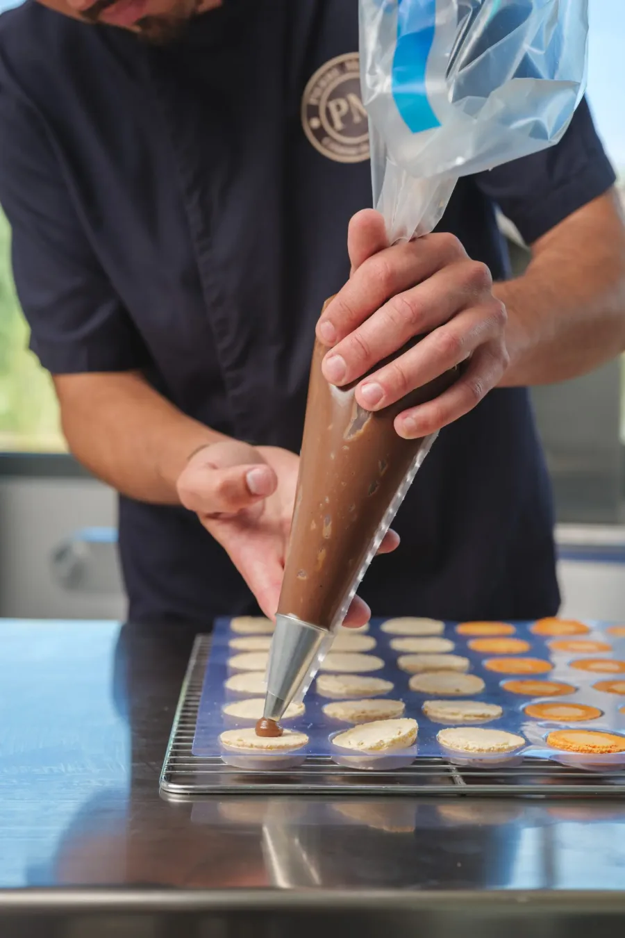 Préparation soignée des macarons, geste précis en atelier